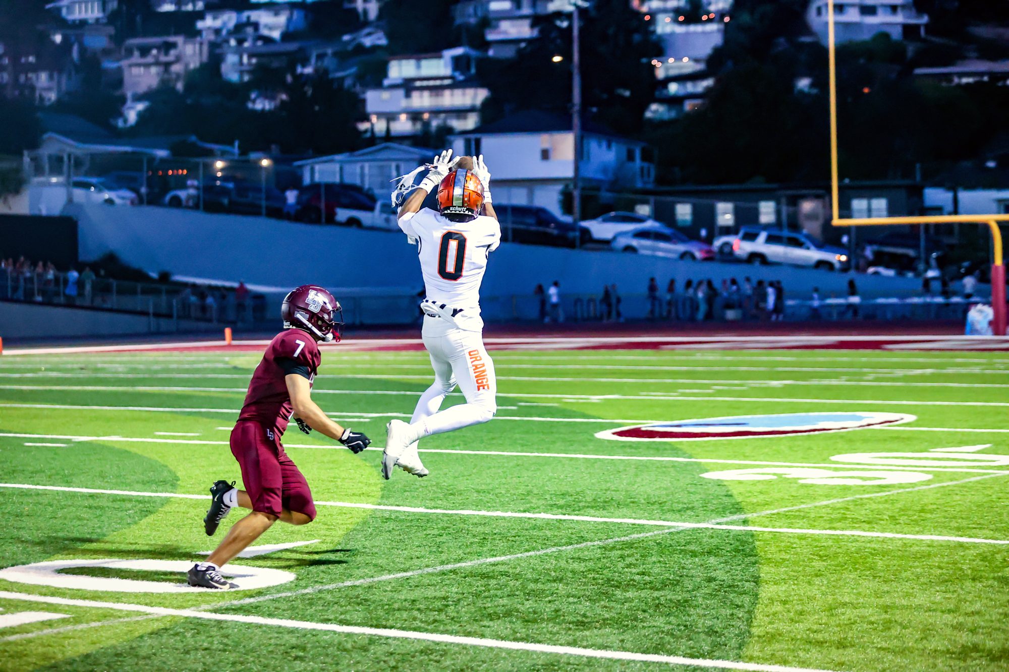 Orange Panthers #0 hauling in a catch at dusk